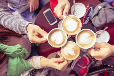 Group of friends drinking cappuccino at coffee bar restaurant - People hands cheering and toasting with upper view point - Social gathering concept with men and women - Vintage marsala filtered look clipart