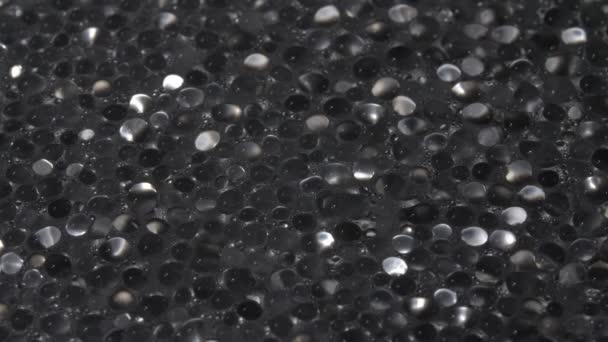 Drops of water close-up. Abstract background. Black base. — Stock Video