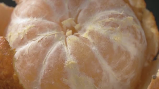 Mandarin with peeled skin. Citrus close-up. Tropical fruit. — Stock Video