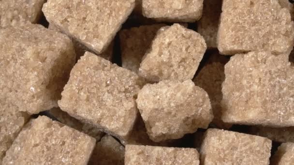 Rotation of sugar lumpy close-up. Brown sugar. Sugar cubes. — Stock Video