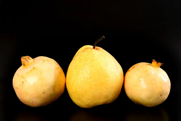 Frische Gruppe orientalische Birne und Granatapfel auf schwarzem Hintergrund — Stockfoto