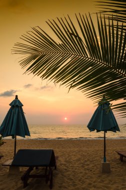 Plaj şemsiye günbatımı ve gökyüzünün siluetleri