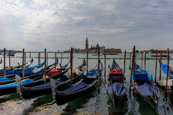Venice's canal, boat and traditional Venetian houses view.
