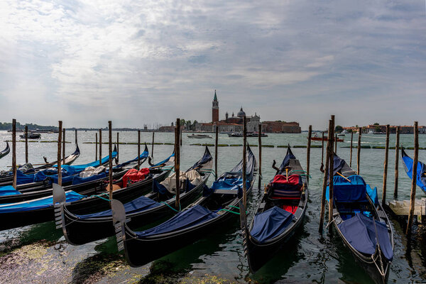 Venice's canal, boat and traditional Venetian houses view.