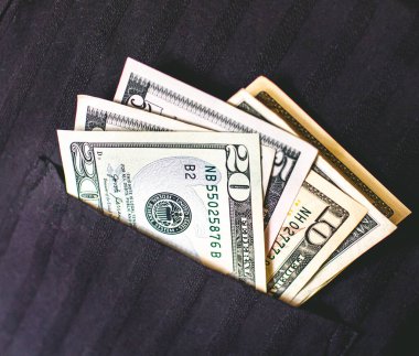 Money, US dollar banknotes background. Photography for Finance and Economy concept.  dollar bills in a black shirt pocket