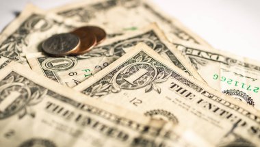 United States dollar bills with a few cent coins. Close up photography. Finance and Economy concept.