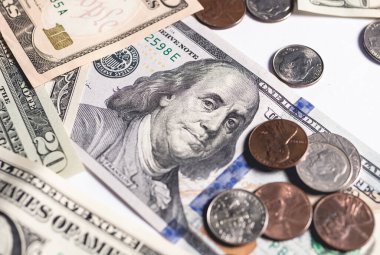 United States dollar bills with a few cent coins. Close up photography. Finance and Economy concept.