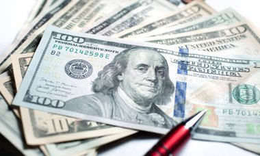 United States dollar banknotes and red pen. Close up photography. Finance and Economy concept.