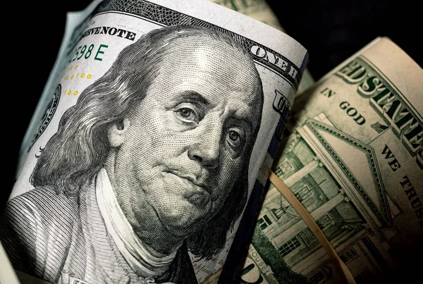 Close up of money background with dollar banknotes rolled up. Economy and finance concept.