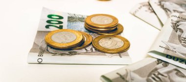 Real, money from Brazil. Dinheiro, Reais, Real Brasileiro, Brasil. Brazilian banknotes in close-up. brazilian banknotes of 200 Reais and coins in close up.