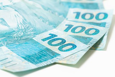 Real, money from Brazil. Dinheiro, Reais, Real Brasileiro, Brasil. Brazilian banknotes in close-up.  brazilian banknotes of 100 Reais  