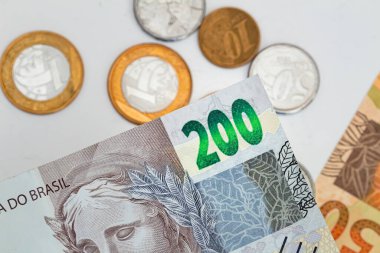 Real, money from Brazil. Dinheiro, Reais, Real Brasileiro, Brasil. Brazilian banknotes in close-up.  brazilian banknotes and coins in close up.