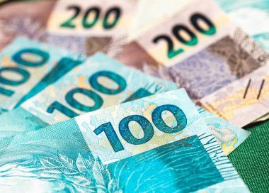 Real, money from Brazil. Dinheiro, Reais, Real Brasileiro, Brasil. Brazilian banknotes in close-up.  brazilian banknotes of 200 and 100 Reais  