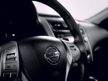 Braslia, Federal District - Brazil. August, 31, 2019. Photograph of the interior of a Nissan brand car. Highlight for the brand emblem on the steering wheel.