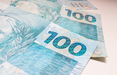 Macro shot of Brazilian reals banknotes on the table