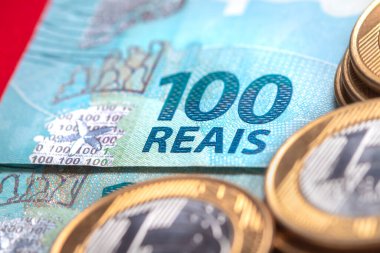 Real coins and Brazilian real banknotes on the table, Investment and economy concept