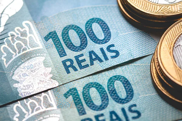 Real coins and Brazilian real banknotes on the table, Investment and economy concept