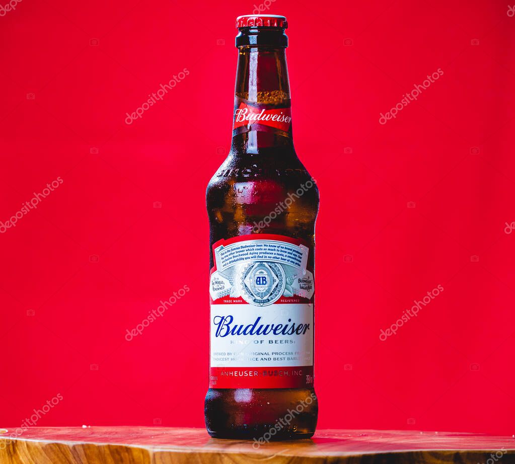 Brasilia, Federal District - Brazil. December, 17, 2019. Studio shot of a Budweiser beer bottle. Red background.