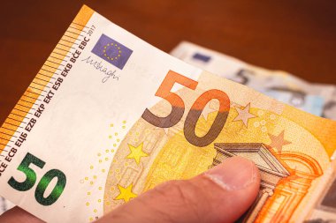 Money, Euro - EUR. European Union Currency. A man holding Euro banknotes. Finance, economy, income and investments concept.