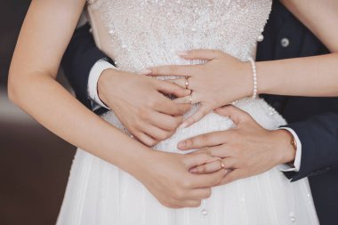 Couple embracing in a tender moment during their wedding ceremony in a beautifully decorated venue filled with love and joy