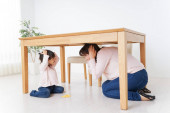 Rodič a dítě skrývající se pod tabulkou. 