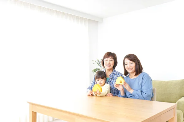 Three generations of women in hunting house interior