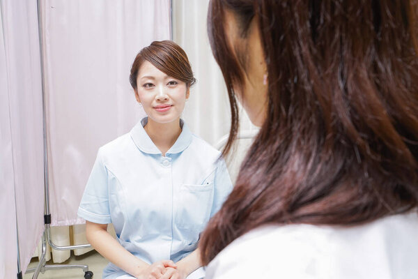  female doctor and nurse doing a meeting.