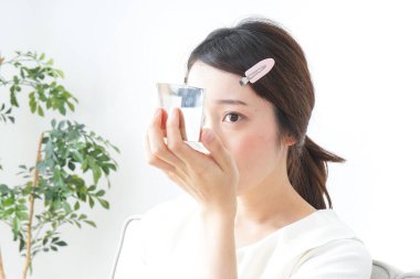 Genç Asyalı kadın makyaj yapıyor.