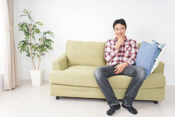 Happy Asian Man Sitting Sofa Home — Stock Photo, Image