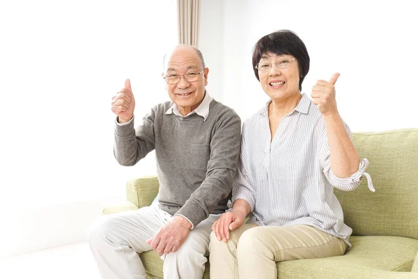 Senior couple giving good sign