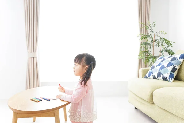 Child drawing pictures at home
