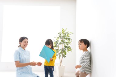 Hemşire ve çocuklar klinikte.