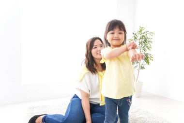 Anne çocuğuyla oynuyor, anne ve kızı birlikte vakit geçiriyorlar.