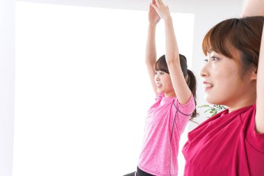 Stüdyoda yoga yapan genç kadınlar.