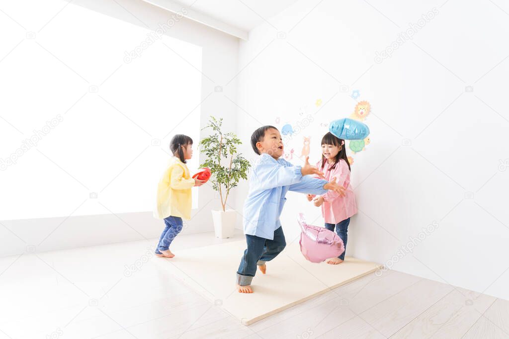 happy Asian children playing at kindergarten