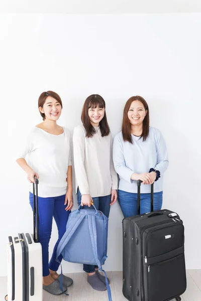 Women's journey, Asian women with suitcases