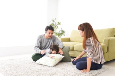 Mutlu genç aile evde oynuyor.
