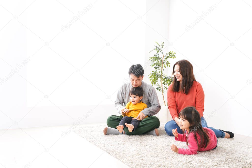 Happy family resting together on the carpet 