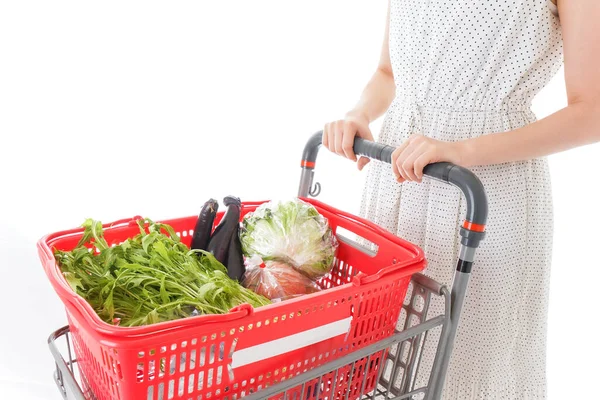 Young housewife with the full shop basket on the white background