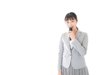 Genç iş kadını mikrofonla konuşuyor.