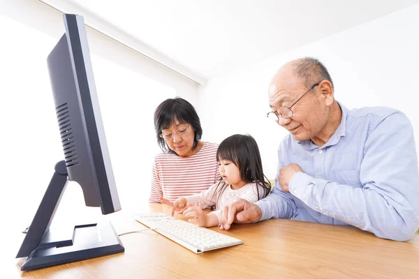 Kind Und Älteres Ehepaar Nutzen Computer — Stockfoto