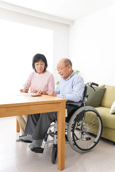 Senior couple signing a document