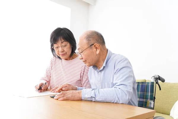 Senior couple signing a document