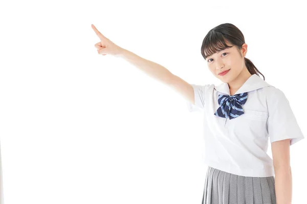 Gülümseyen Genç Asyalı Kız Öğrenci Bir Şeyi Işaret Ediyor — Stok fotoğraf