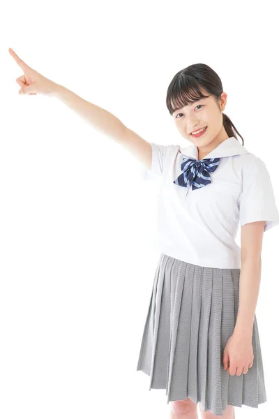 Uśmiechnięta Młoda Azjatycka Studentka Wskazująca Coś — Zdjęcie stockowe