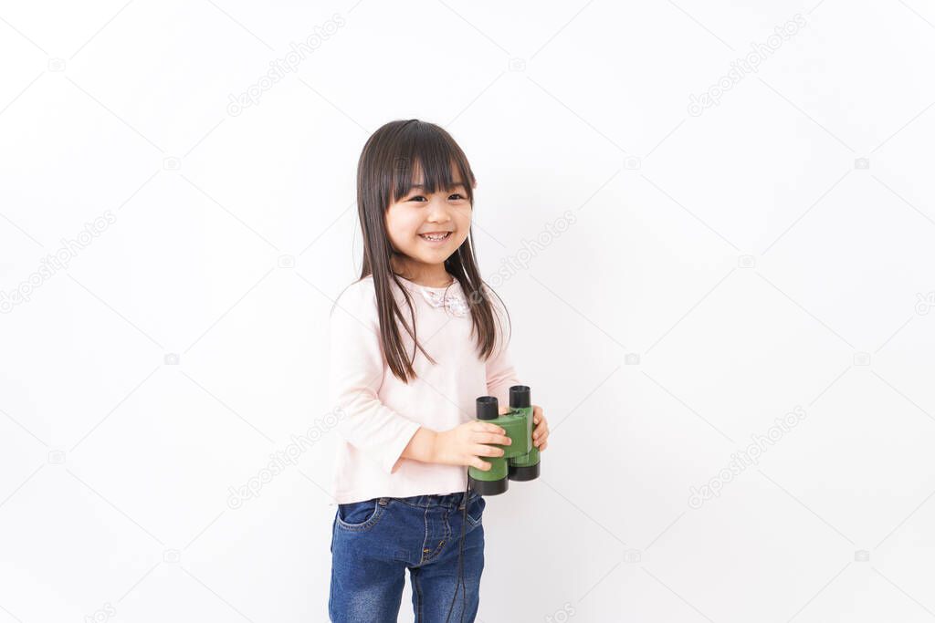 Small child using a binoculars