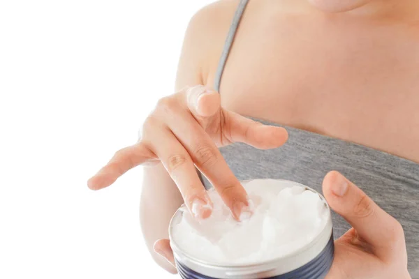 Young woman using cream to the face
