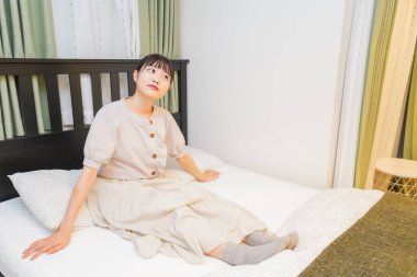 Genç kadın yatakta dinleniyor.