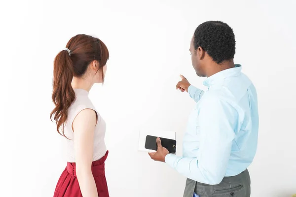 Young woman showing the way for foreign tourist