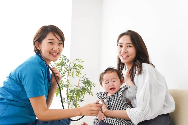 Mom with her baby receive an examination at the hospital, Doctor examining a baby